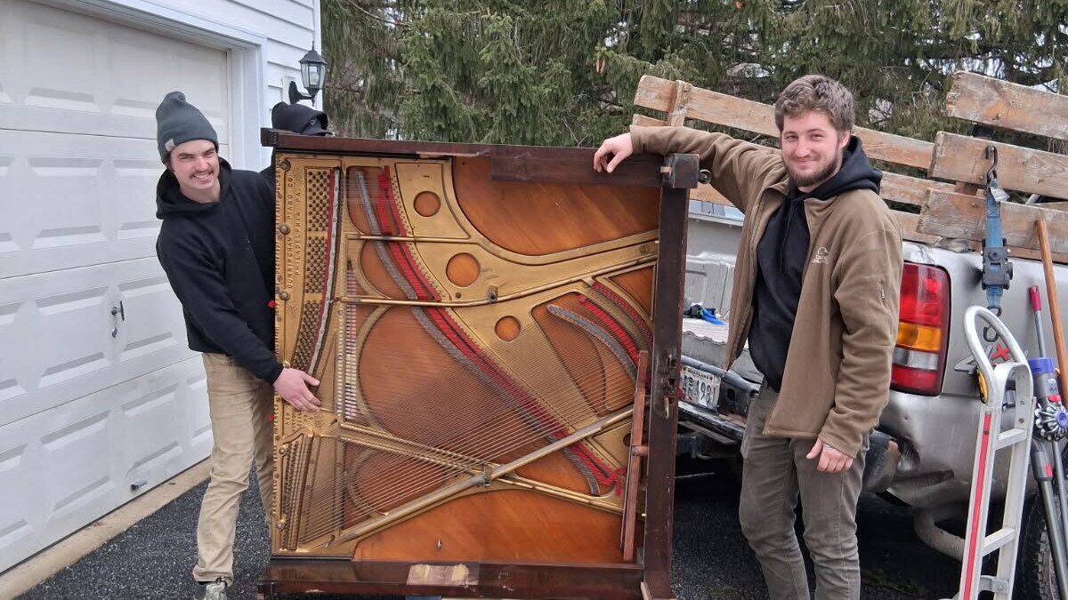 Grime To Dime crew hauling a piano from a Howard County driveway