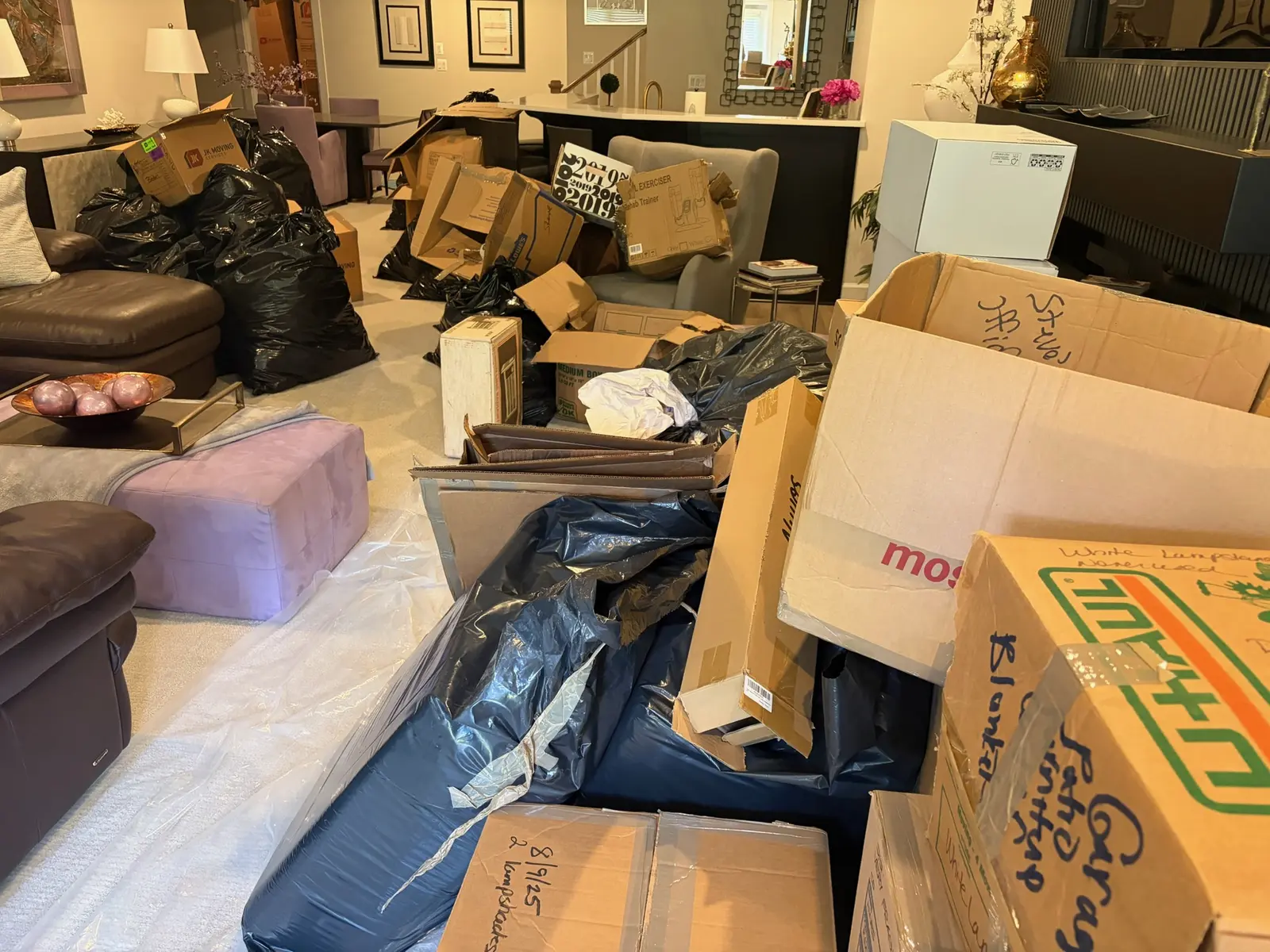 Fulton Maryland basement before junk removal with boxes and unwanted items throughout the room